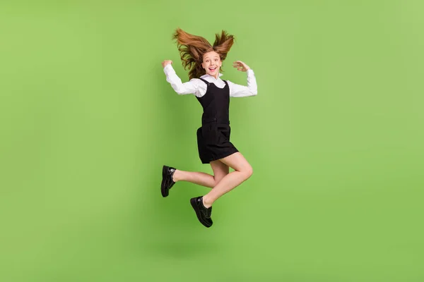 Full length body size view of attractive cheerful girl jumping having fun good mood isolated over green color background —  Fotos de Stock