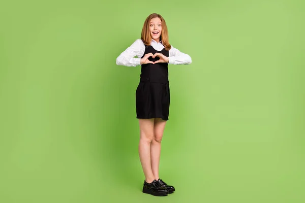 Full length body size view of affectionate cheerful amazed girl showing heart sign isolated over green color background —  Fotos de Stock