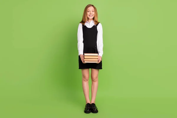 Full length body size view of attractive cheerful smart girl holding book dictionary isolated over green color background — 스톡 사진