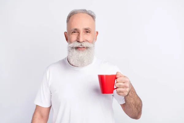 Photo of attractive cheerful happy grandfather hold red cup of coffee smile isolated on grey color background — ストック写真