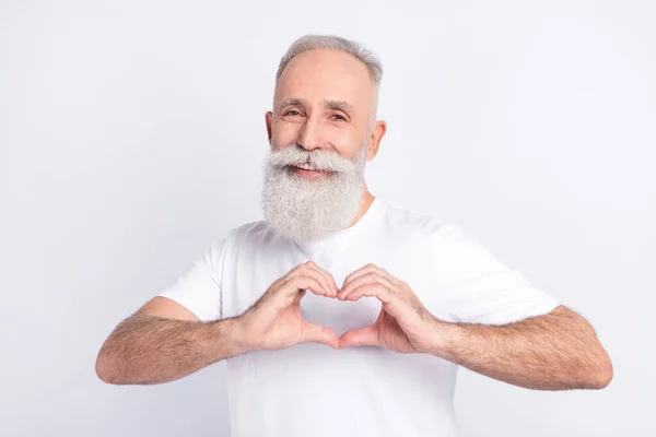 Portrait of attractive cheerful man boyfriend showing heart shape sign symbol isolated over light grey color background — Foto de Stock