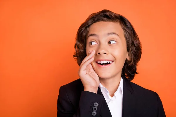 Photo of young brunette happy positive dreamy amazed boy look empty space say news isolated on orange color background —  Fotos de Stock