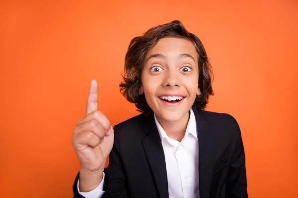 Photo of young happy smart shocked astonished small boy point finger up idea isolated on orange color background —  Fotos de Stock