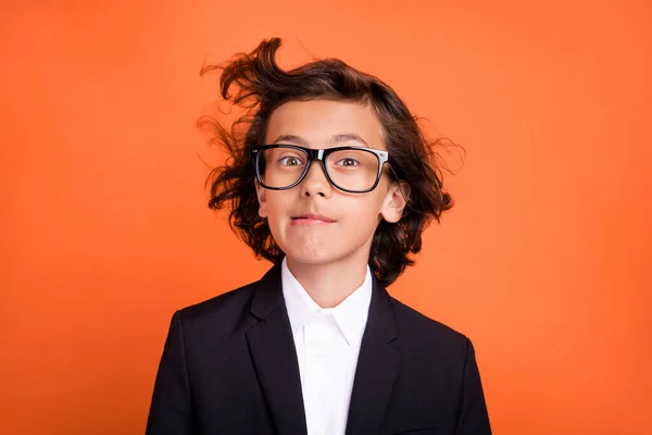 Photo of young funny funky happy boy wind blow hair wear formalwear suit isolated on orange color background — Stok fotoğraf