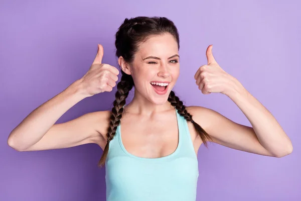 Portrait of attractive cheerful girl winking showing two double thumbup isolated over violet purple color background — Foto de Stock