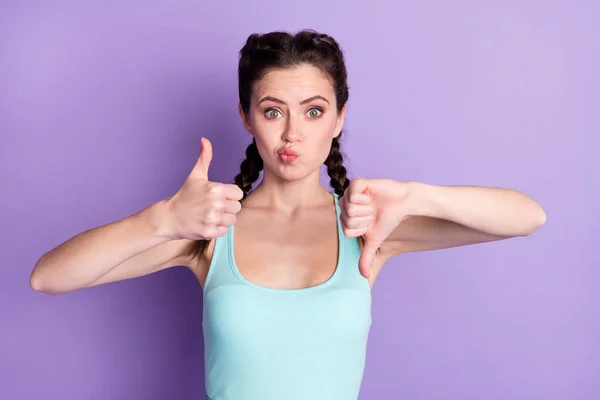 Photo of unsure puzzled young woman make hands thumbs up down dilemma isolated on purple color background — Foto Stock