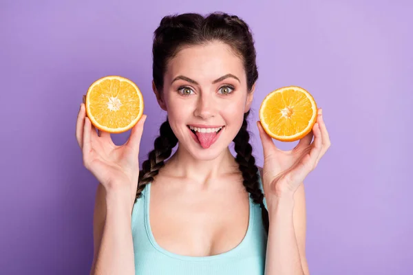Portrait of nice funky brown hair lady hold orange tongue out wear blue top isolated on pastel purple background —  Fotos de Stock
