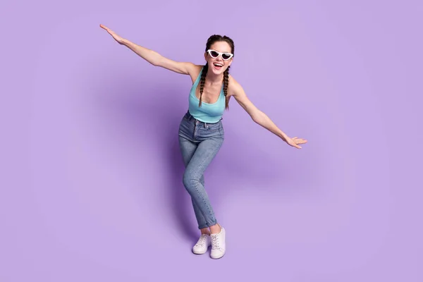 Full length body size view of attractive cheerful childish girl having fun flying like plane isolated over violet purple color background — Foto de Stock