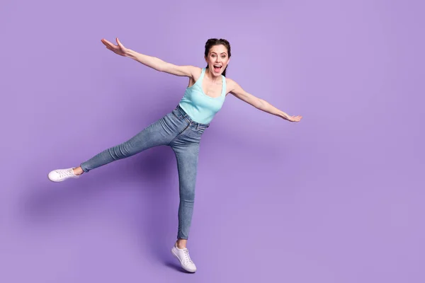 Full length body size view of pretty cheerful carefree girl flying having fun good mood isolated over violet purple color background — Stok fotoğraf