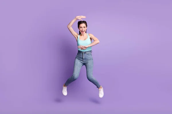 Full length body size view of cheerful childish girl jumping having fun posing isolated over violet purple color background —  Fotos de Stock