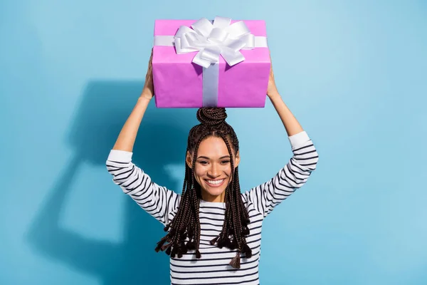 Photo portrait of girl with dreadlocks keeping pink big present isolated pastel blue color background — ストック写真