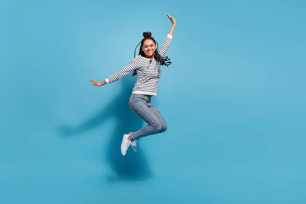 Full size profile side photo of young cheerful african girl happy positive smile have fun jump isolated over blue color background — Foto de Stock