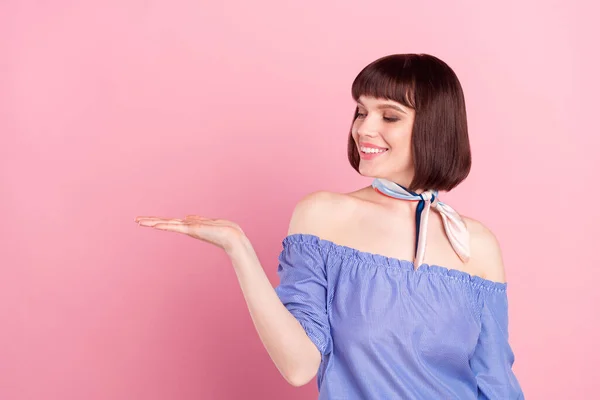 Photo of happy nice pretty cute young woman hold hand empty space look isolated on pink color background — Foto Stock