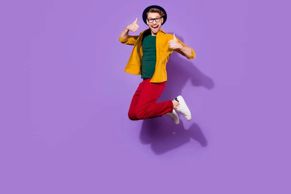 Full length body size view of nice cheerful guy jumping showing thumbup isolated over bright violet purple color background — ストック写真