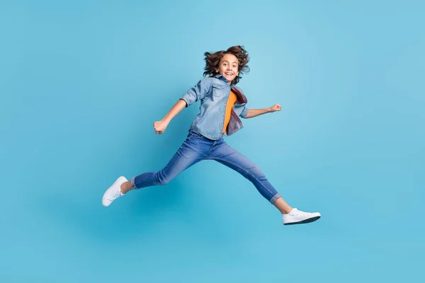 Full length profile side photo of young boy jump up go walk run isolated over blue color background — ストック写真