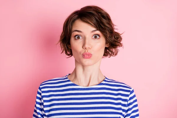 Photo of lovely romantic girl pout lips send air kiss look camera wear striped shirt isolated pastel pink color background — Stock Photo, Image