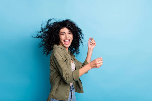 Photo of funny excited person enjoy dancing open mouth hair flying isolated on blue color background