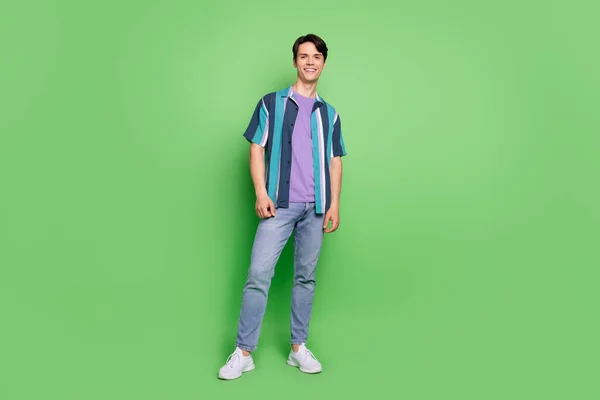 Full body photo of charming happy positive man wear casual clothes smile isolated on green color background — ストック写真