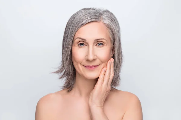 Photo of lovely charming attractive old woman hold hands touch face skin treatment isolated on grey color background — Stock Photo, Image