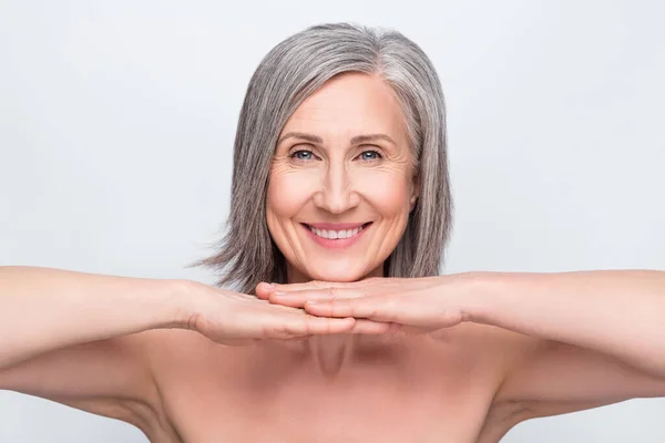 Porträtt av attraktiva naken glad kvinna visar felfri hud hygien isolerad över grå pastell färg bakgrund — Stockfoto