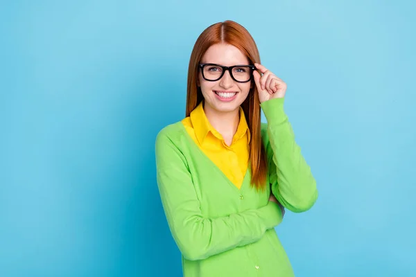 Photo of lovely young student lady touch spectacles wear green sweater isolated on blue color background — ストック写真