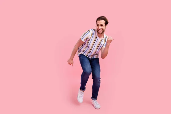 Full body photo of charming young happy man look empty space dance funky isolated on pastel pink color background — Stock Photo, Image