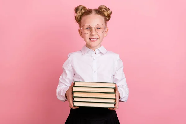 Photo of smart small girl hold books wear white shirt spectacles isolated on pastel pink background — Stock Photo, Image