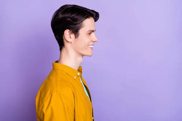 Profile photo of optimistic brunet millennial guy look empty space wear brown shirt isolated on violet color background — Stock Photo, Image