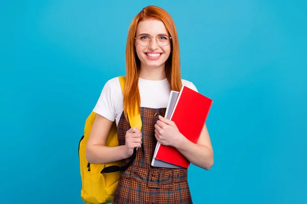 Foto di giovane ragazza della scuola felice sorriso positivo tenere zaino studente notebook lezione isolato su sfondo di colore blu — Foto Stock