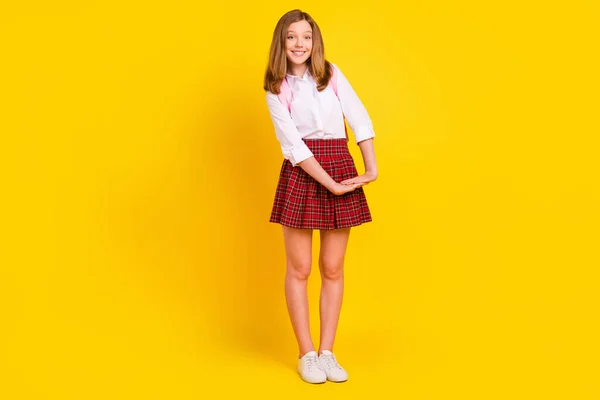 Full length photo of cute small girl hold hands wear shirt skirt bag sneakers isolated on yellow background — Stock Photo, Image