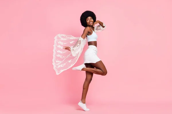 Full body profile side photo of happy nice young afro american lady look copyspace walk isolated on pink color background — Photo