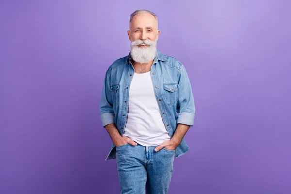 Photo of handsome aged man happy positive smile hands in pocket go walk isolated over violet color background — Stock Photo, Image