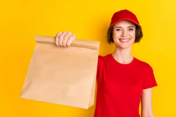 Photo of nice optimistic brown hair lady hold bag wear t-shirt cap isolated on yellow background — Stok fotoğraf