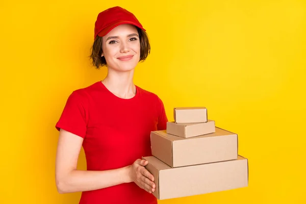 Photo of nice optimistic brown hair lady hold box wear t-shirt cap isolated on yellow background — Stok fotoğraf