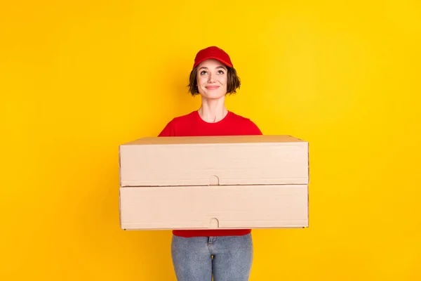 Photo portrait of female worker keeping two big boxes looking up on empty space isolated on bright yellow color background — Stok fotoğraf