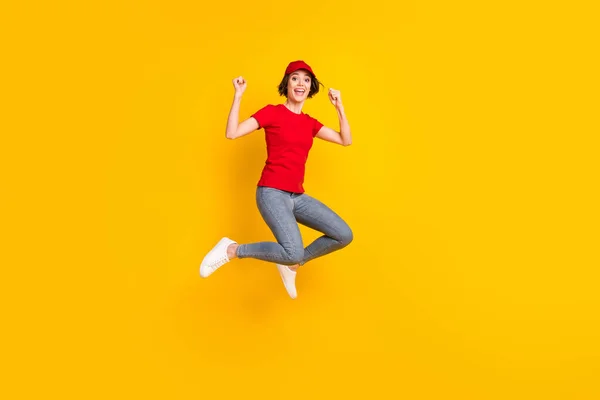 Full size profile photo of nice optimistic brown hair lady jump wear t-shirt cap isolated on yellow background — Fotografia de Stock