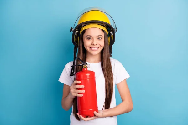 Foto van jong meisje blij positieve glimlach dragen helm brandweerman redder geïsoleerd over blauwe kleur achtergrond — Stockfoto