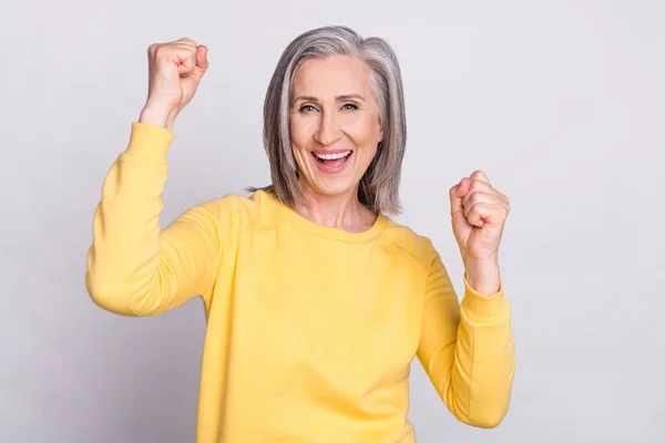 Photo of happy cheerful excited crazy grandmother raise fists in victory success isolated on grey color background — Foto Stock