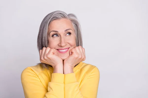 Photo of happy good mood dreamy charming mature woman look copyspace adoring isolated on grey color background — Stockfoto