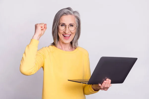 Photo of happy excited cheerful businesswoman hold laptop raise fist in victory isolated on grey color background — Fotografia de Stock