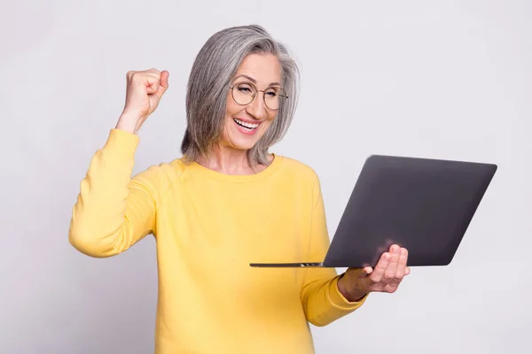 Photo of happy excited crazy mature businesswoman raise fists in victory success isolated on grey color background — Photo