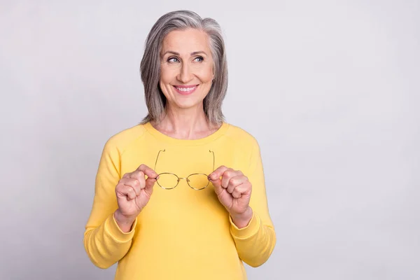 Photo of cheerful smiling pretty mature woman look copyspace dreaming thinking isolated on grey color background — Stockfoto