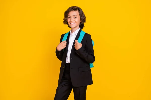 Photo of cheerful positive little schoolboy wear rucksack black uniform isolated yellow color background — Stock Photo, Image