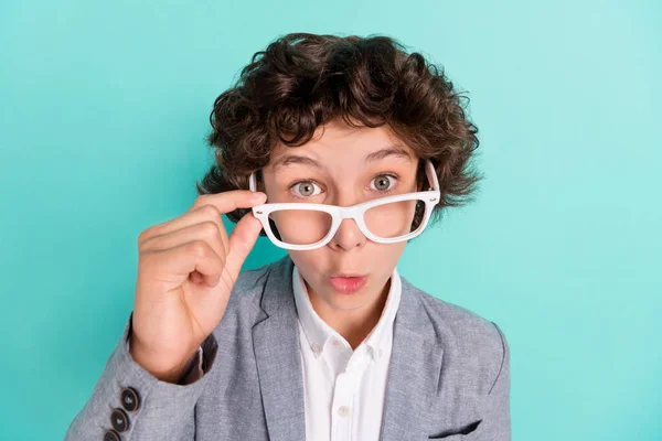 Photo of adorable impressed school boy wear grey jacket arm spectacles big eyes isolated turquoise color background — Foto de Stock