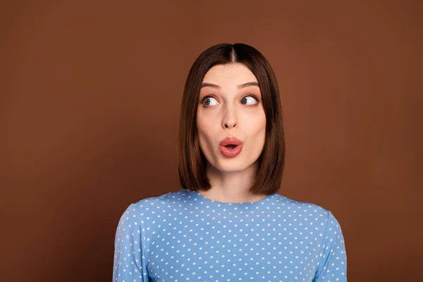 Photo of staring brunette millennial lady look empty space wear dotted shirt isolated on brown color background — Photo