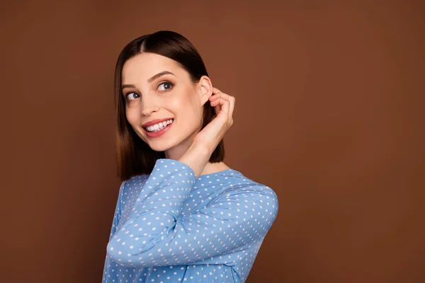 Photo of cute brunette young lady look empty space wear dotted shirt isolated on brown color background —  Fotos de Stock