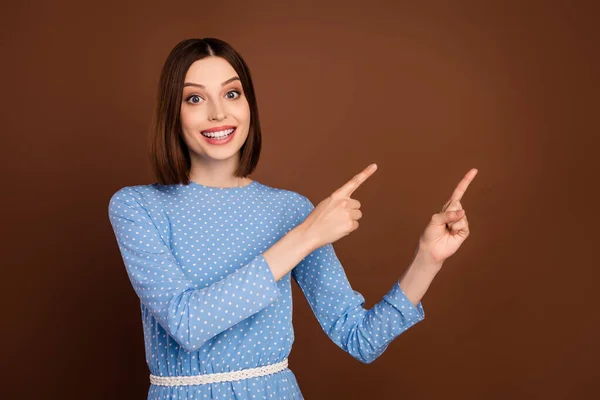 Photo of funny bob hairdo young lady point empty space wear blue blouse isolated on brown color background — Photo