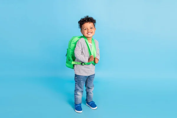 Plná délka tělo velikost pohled na pěkný veselý chlapec jít do první třídy izolované přes jasně modré barvy pozadí — Stock fotografie