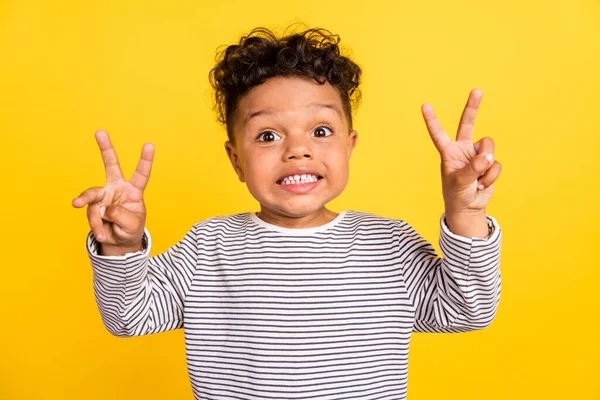 Stock image Photo portrait small boy smiling showing v-sign gesture isolated vivid yellow color background