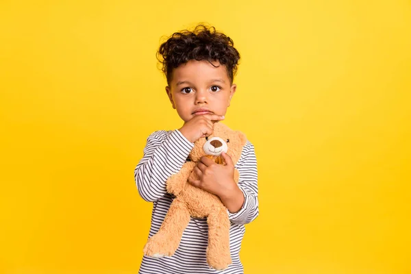 Foto retrato niño pequeño lindo abrazo suave osito de peluche reflexivo aislado vibrante color amarillo fondo —  Fotos de Stock